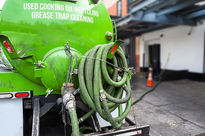 a grease trap being pumped by a sanitation technician in Olmsted Falls